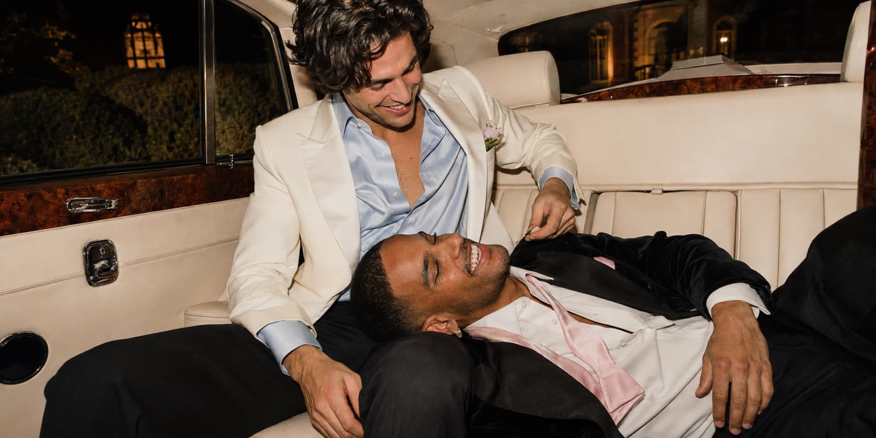 An intimate moment between two people at a formal gathering