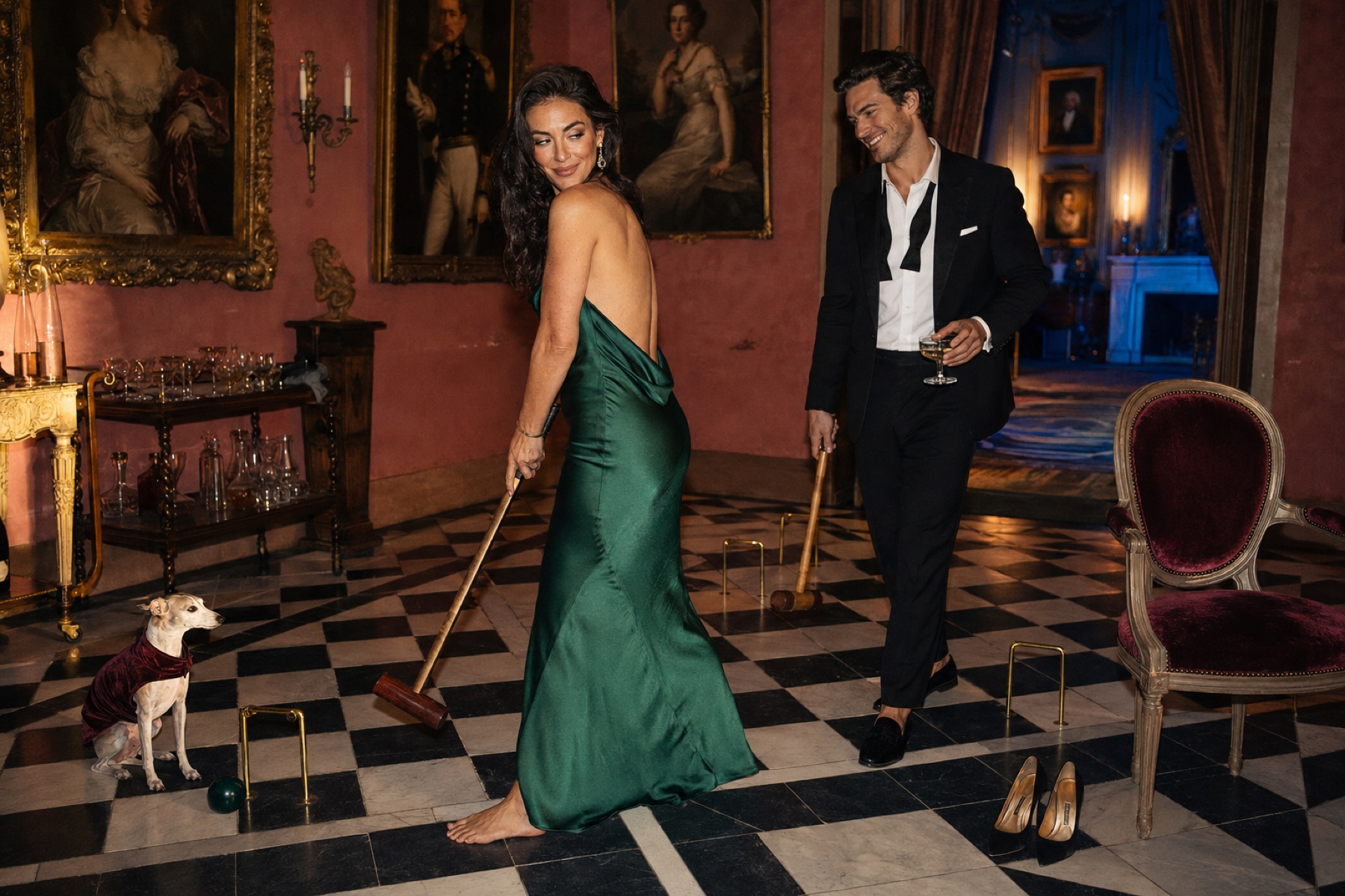 Two people playing croquet in a candlelit drawing room